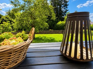 A wooden deck with a wicker basket and a metal lantern. - Herzwerk Schwalenberg by Interhome (Schwalenberg)