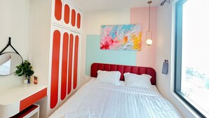 A bedroom with a bed, a desk, a wardrobe, a painting, and a window. - SOHO Vernal Saigon Apartments (Ho Chi Minh City)