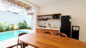 A modern kitchen with a built-in microwave, refrigerator, and water dispenser. - Villa Harmony (Badung)