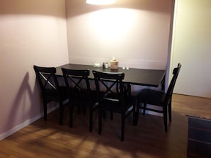 A dining area with a rectangular table and four chairs.