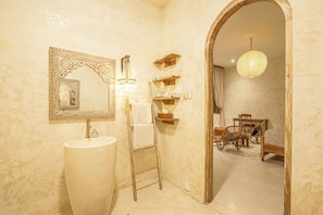 A bathroom with a large sink, a mirror with ornate frame, a chandelier, and a wooden ladder. - Stylish 3BR Villa Uluwatu Enclosed Living & AC (Pecatu)