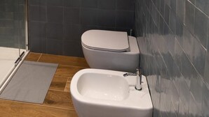 Un bagno con doccia, WC e bidet.