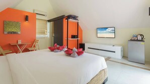 A hotel room with a bed, a desk, a chair, a wardrobe, a television, and a refrigerator. - Beach Villa 21D Blue Haven Bay Resort - 4 rooms (Ko Chang)