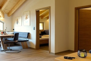 A room with a bed, a desk, and a chair. There are framed pictures on the wall. - Panoramic View Suite on the Kaunergrat (Kaunerberg)