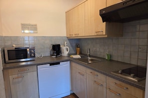 A kitchen with a microwave, coffee maker, sink, and dishwasher. - Holiday apartment near Lake Achensee (Achenkirch)