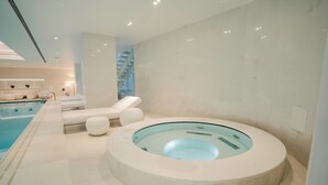 A modern spa area with a circular hot tub, lounge chairs, and a pool. - Luxury Villa Katino Estate with Private Pool & Sea Views (Šipanska Luka)
