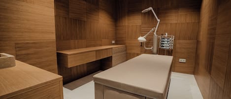 A modern bathroom with wooden walls, a vanity, a sink, and a shower area.