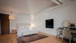A modern bedroom with a bed, bedside table, lamp, and a desk with a chair. - Luxury Villa Katino Estate with Private Pool & Sea Views (Šipanska Luka)