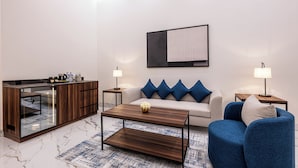 A modern living room with a sofa, coffee table, and a sideboard.