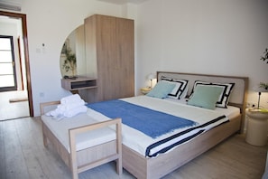 A bedroom with a bed, bedside tables, a wooden wardrobe, a mirror, and a door. - Casa Estilo Deco Luxury Villa with Saltwater Pool (Biograd na Moru)