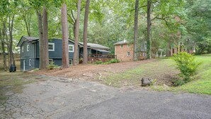 A residential property with two houses, one with a porch and a covered deck, surrounded by a wooded area. - Fire Pit & Grill! Wooded Durham Retreat (Durham)