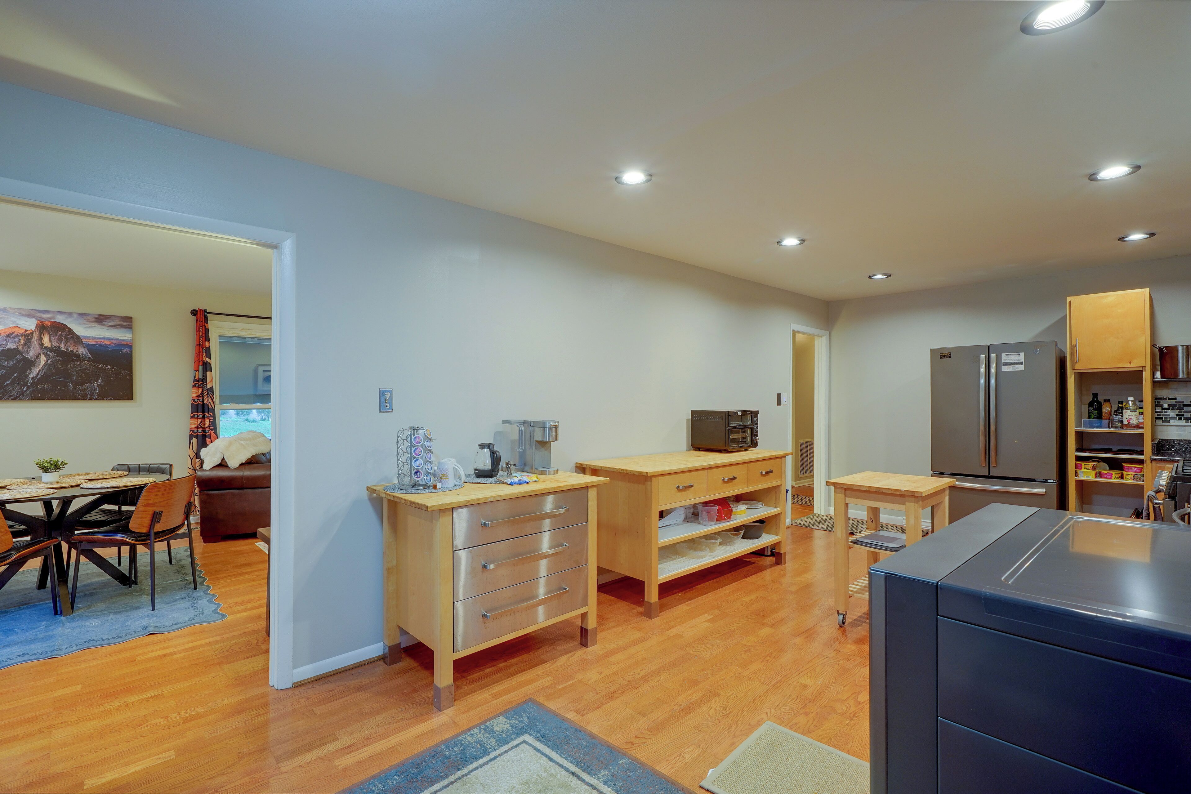 A modern kitchen with wooden cabinets, a refrigerator, and a microwave.