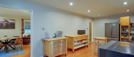 A modern kitchen with wooden cabinets, a refrigerator, and a microwave.