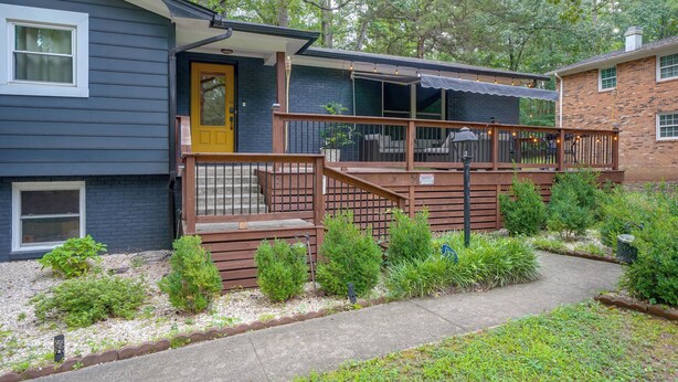 A residential property with a covered porch, a front door, and a small garden area. - Fire Pit & Grill! Wooded Durham Retreat (Durham)