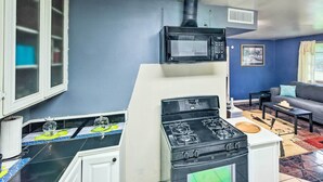 A compact kitchen with a stove, microwave, and a small window. - Family Home + Guest House! Near Fishing, Boat Ramp (West Orange)