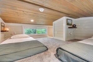 A bedroom with two beds, a window, a ceiling light, and a wall-mounted shelf with a picture. - Tiny Home - Fire Pit, Grill, Deck & View! (Franklin)