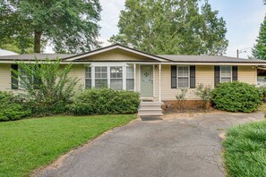 A single-story house with a front porch, a door with a decorative glass panel, and a small set of steps leading to the entrance. - Dock & Outdoor Bar! Lake Blackshear Getaway (Cobb)