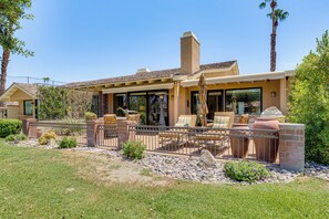A house with a patio, outdoor seating, and a view of the surrounding landscape. - Extended Getaway in the Heart of Palm Desert (Palm Desert)