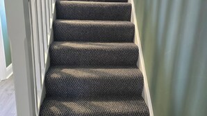 A staircase with a textured carpet and wooden handrail, leading to a room with a green wall. - BridAj's Place is a full Semi-detached 3 Bed home with parking full of History. (Belfast)