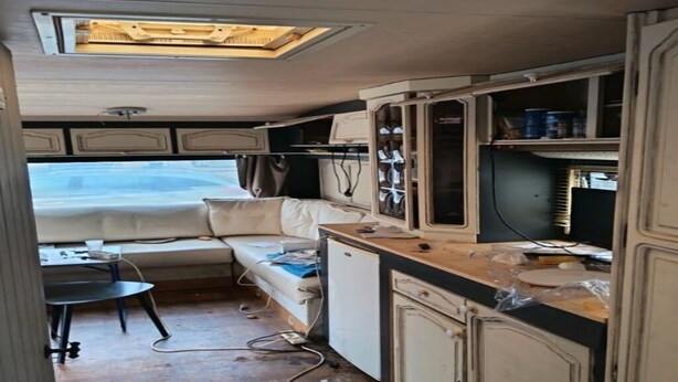 A compact kitchenette with a refrigerator, a small sink, and a countertop. - Large Tabbert trailer located near the sea in Hyères—secure Beldemé campground (Hyères)