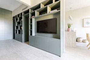 A modern living room with a built-in entertainment unit, a flat-screen TV, and a minimalist design. - [Casa Mafalda] Design Home/Portovenere-5Terre+A/C (Portovenere)