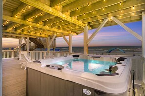 A hot tub on a wooden deck with a view of the ocean. - Luxury Oceanfront Home w/ Hot tub and Community Pool (North Topsail Beach)