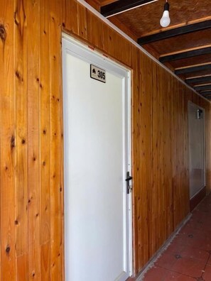A wooden door with a sign indicating room number 305. - Sky view homestay (Ta Van)
