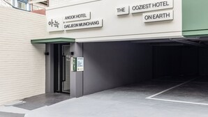 The exterior of a hotel with signage indicating 'Anook Hotel' and 'The Coziest Hotel on Earth.' - Anook Hotel Daejeon Munchang (Daejeon)