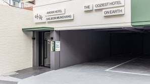 The exterior of a hotel with signage indicating 'Anook Hotel' and 'The Coziest Hotel on Earth.'