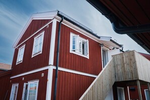 A red building with white trim and multiple windows.