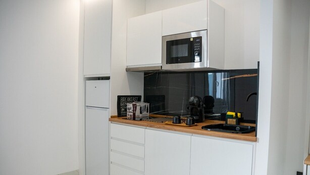 A compact kitchen with white cabinets, a microwave, a coffee maker, and a toaster. - AP Alsa 02 with Shared Terrace, WiFi, and Air Conditioning (Conil de la Frontera)