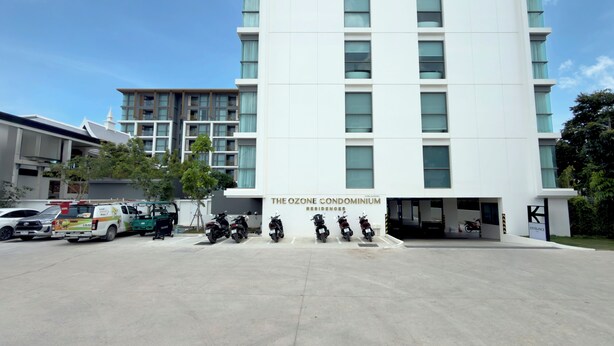 A modern building with a sign reading 'The Ozone Condominium Residences.' - Bangtao Laguna Apartment 42 sq.m (Thalang District)