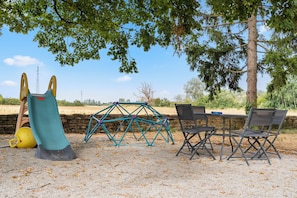 A playground with a slide, swings, and a climbing structure. - A 10-minute drive from Beaune, on a vineyard estate, a charming Burgundian house. (Corcelles-les-Arts)