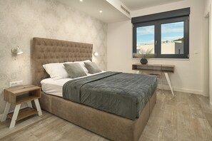 A bedroom with a large bed, bedside tables, a desk, and a window with a view. - Luxury villa Natali with pool, terrace and sea view (Podstrana - Sita)