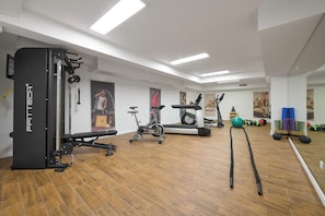 A gym with exercise equipment, wooden flooring, and white walls. - Luxury villa Natali with pool, terrace and sea view (Podstrana - Sita)