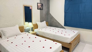 A hotel room with two beds, a nightstand, a lamp, a mirror, and a blue curtain. - Silver Lantern Hanoi Hotel (Hanoi)