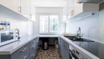Een koffiezetapparaat/waterkoker, een koelkast, een magnetron, een oven