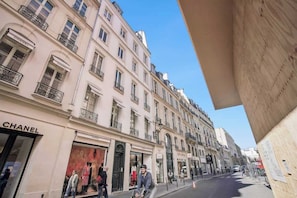 A street view with a Chanel store, pedestrians, and classic European architecture. - Fully Equipped Studio – Concorde – Mobility Lease (Paris)