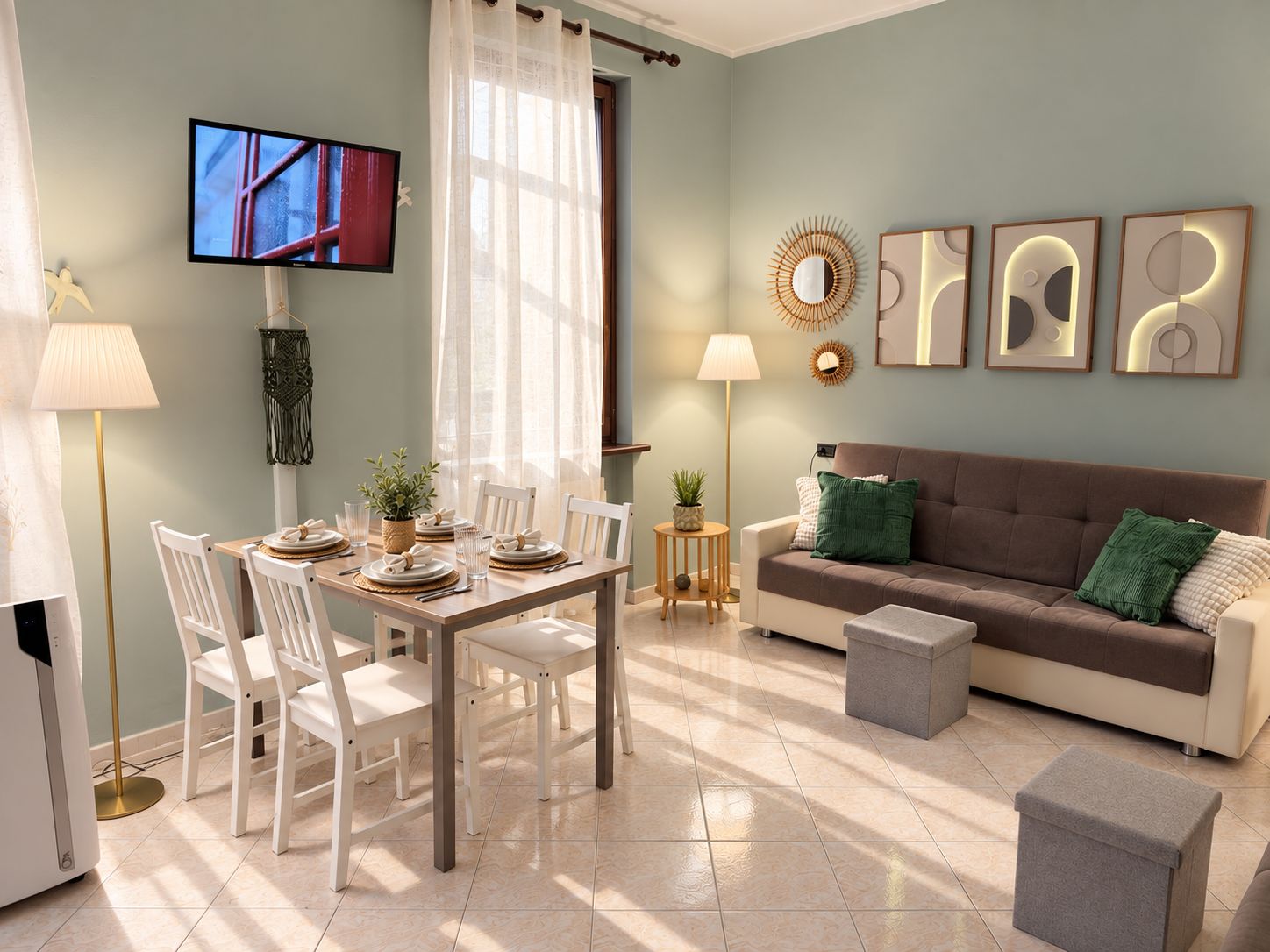 A modern living room with a dining area, a sofa, and a television.