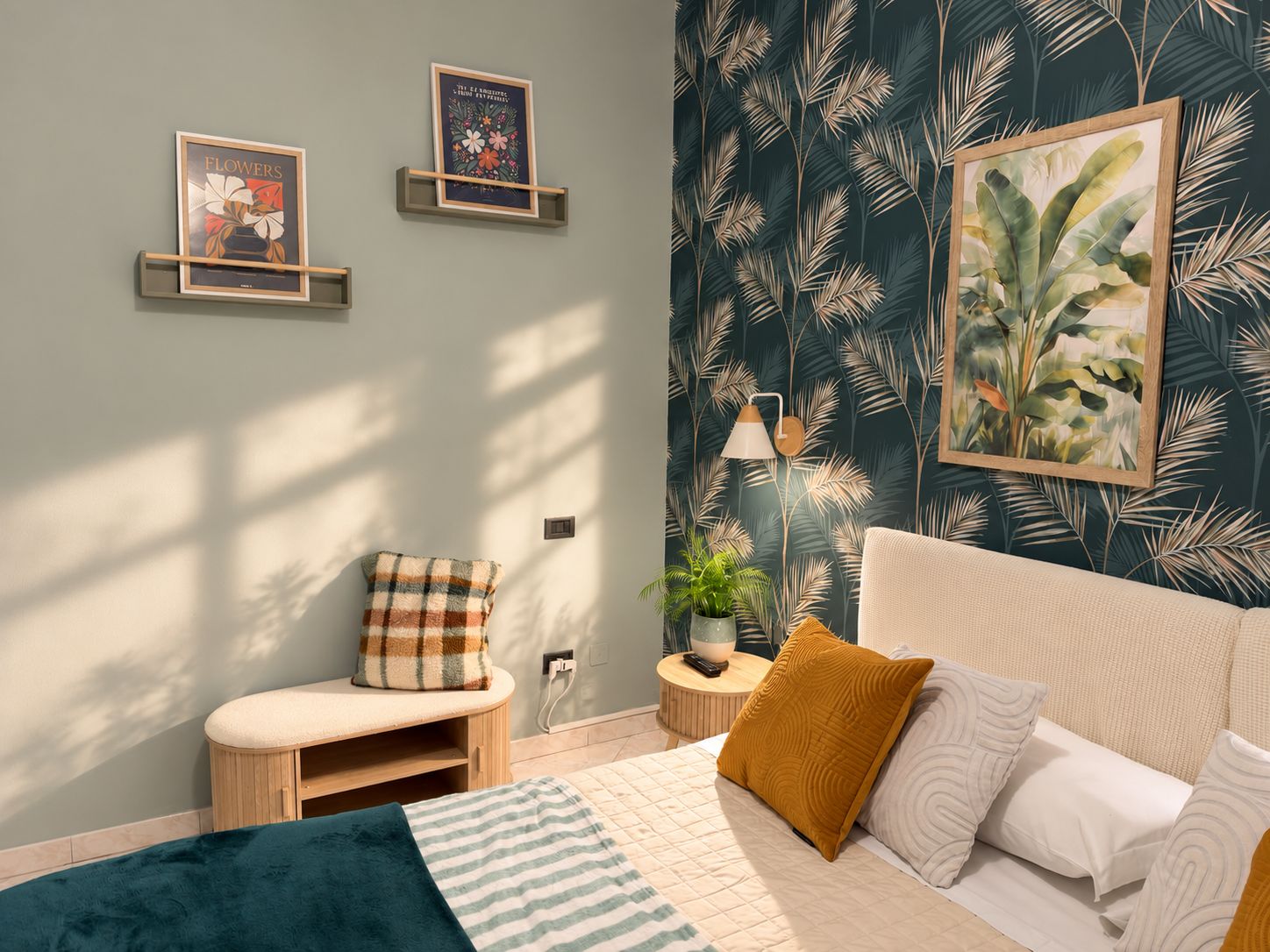 A bedroom with a bed, a nightstand, a lamp, a potted plant, and wall art.