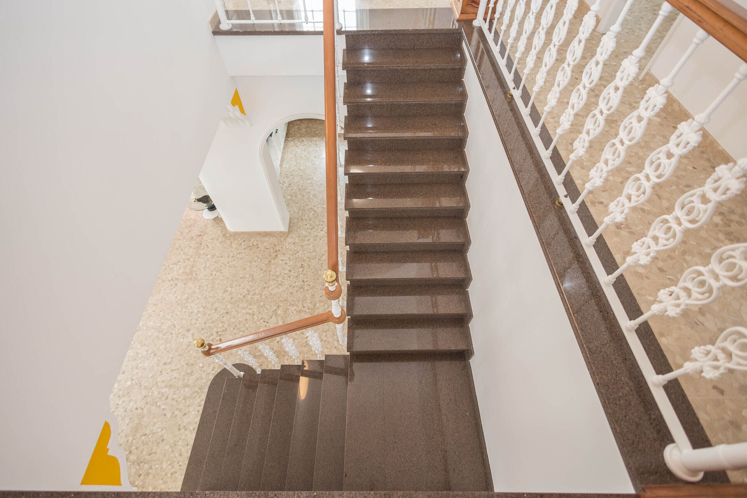 A staircase with a handrail and a carpeted landing.