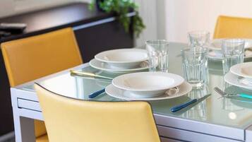 A dining table set with plates, glasses, and cutlery.