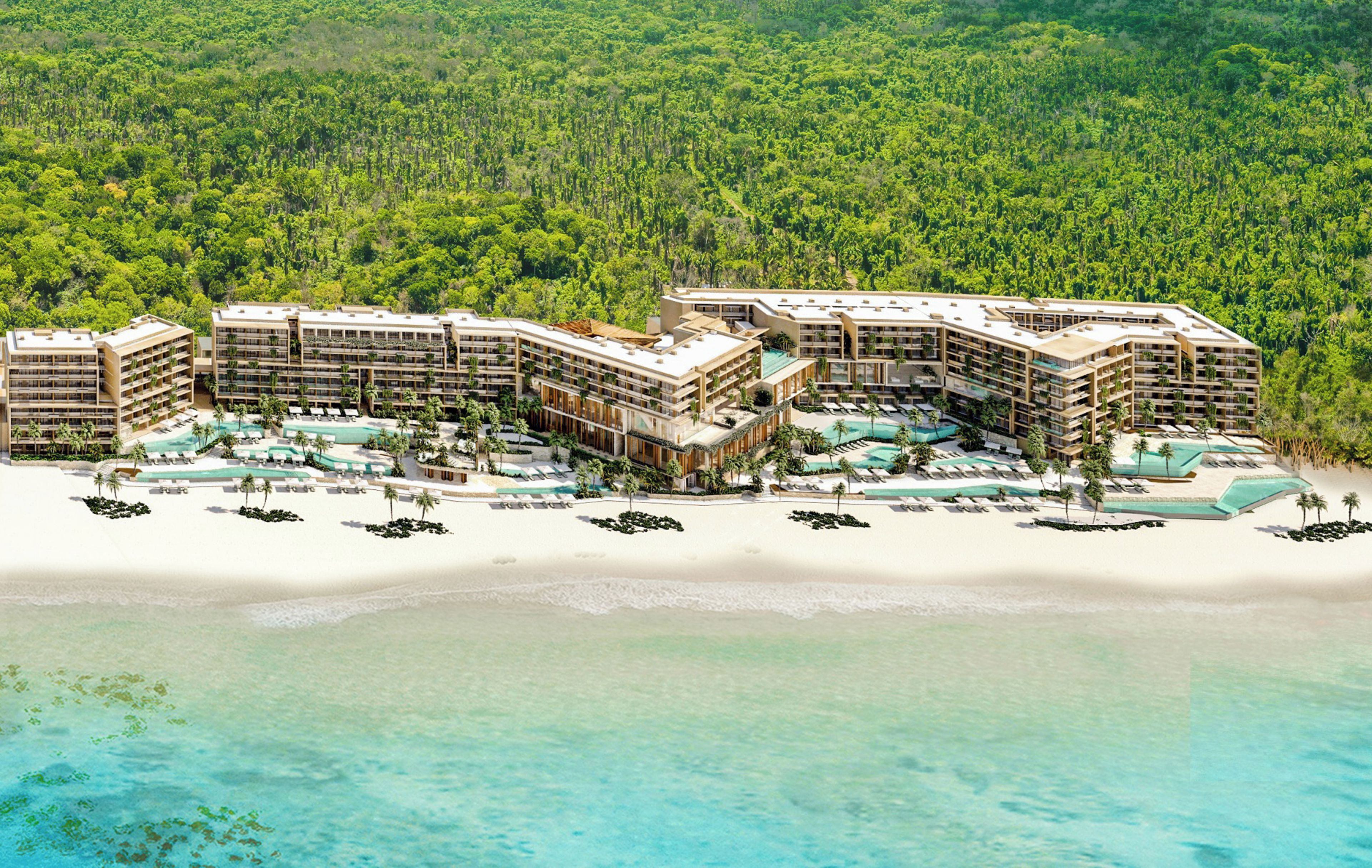 A resort with multiple buildings, a beachfront, and a pool area.