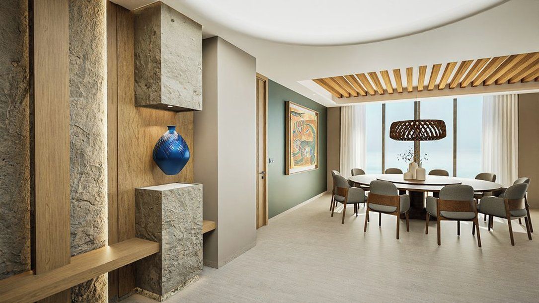 A modern dining area with a round table and chairs, a blue vase on a shelf, and a large window with a view.