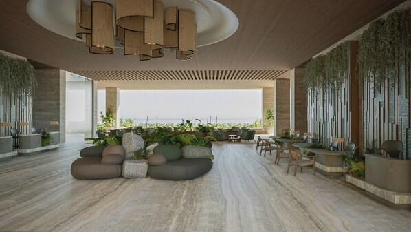 A modern lounge area with seating, a view of the sea, and a ceiling with a unique light fixture.