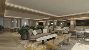 A modern living room with a sofa, armchairs, a coffee table, and a TV.