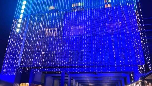 A building with a modern design, featuring a series of vertical light strips and a covered entrance area. - Odyssey Rendezvous (Kunnathunad)