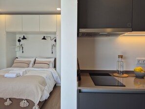 A modern bedroom with a bed, bedside lamps, and a nightstand.