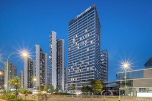 A high-rise building with multiple floors and a prominent sign at the top. - Poltton International Apartment (Liuzhou Yaobu Ancient Town Panlongshan) (Shantou)