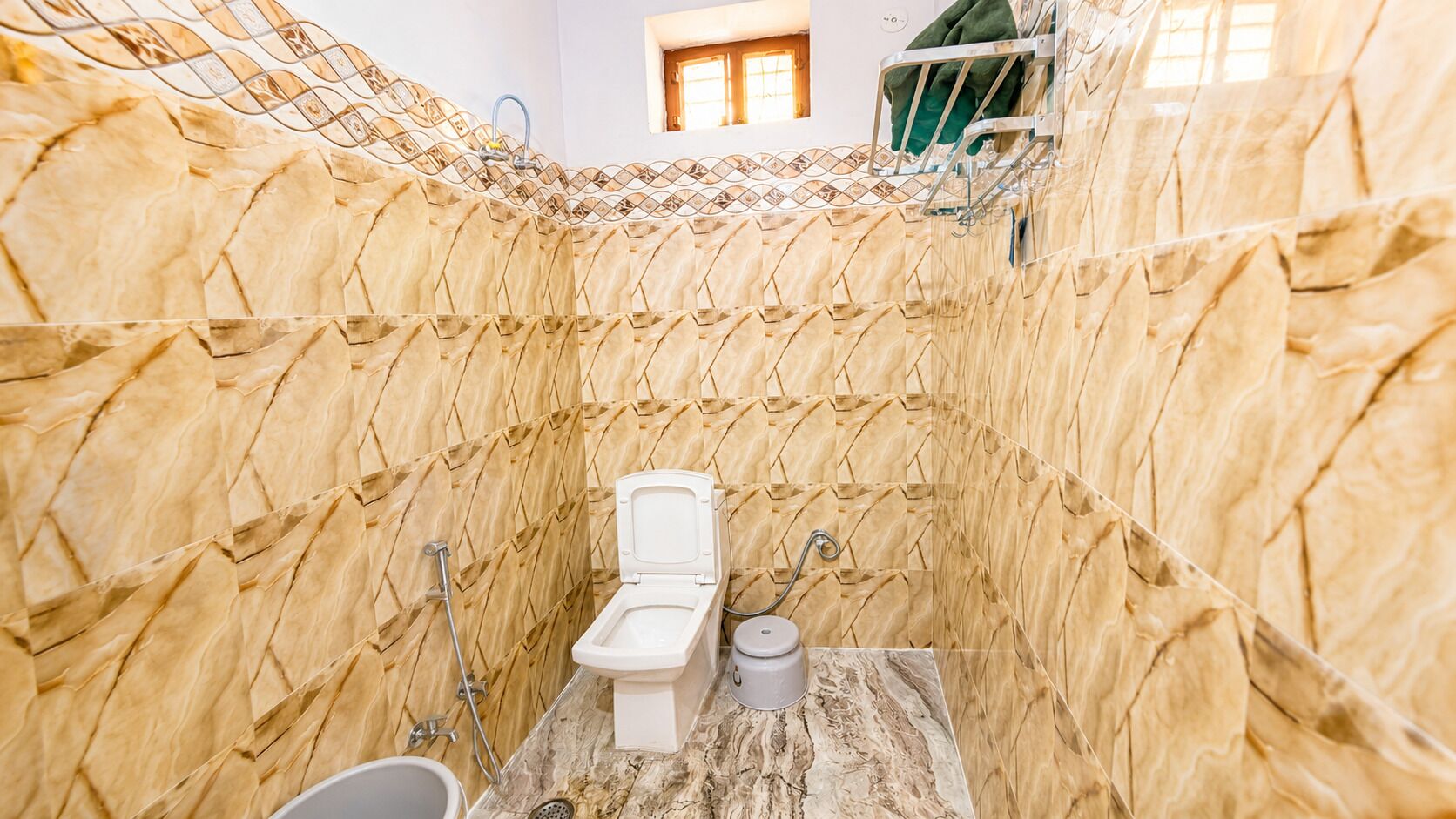 A bathroom with a toilet, a sink, and a shower area.
